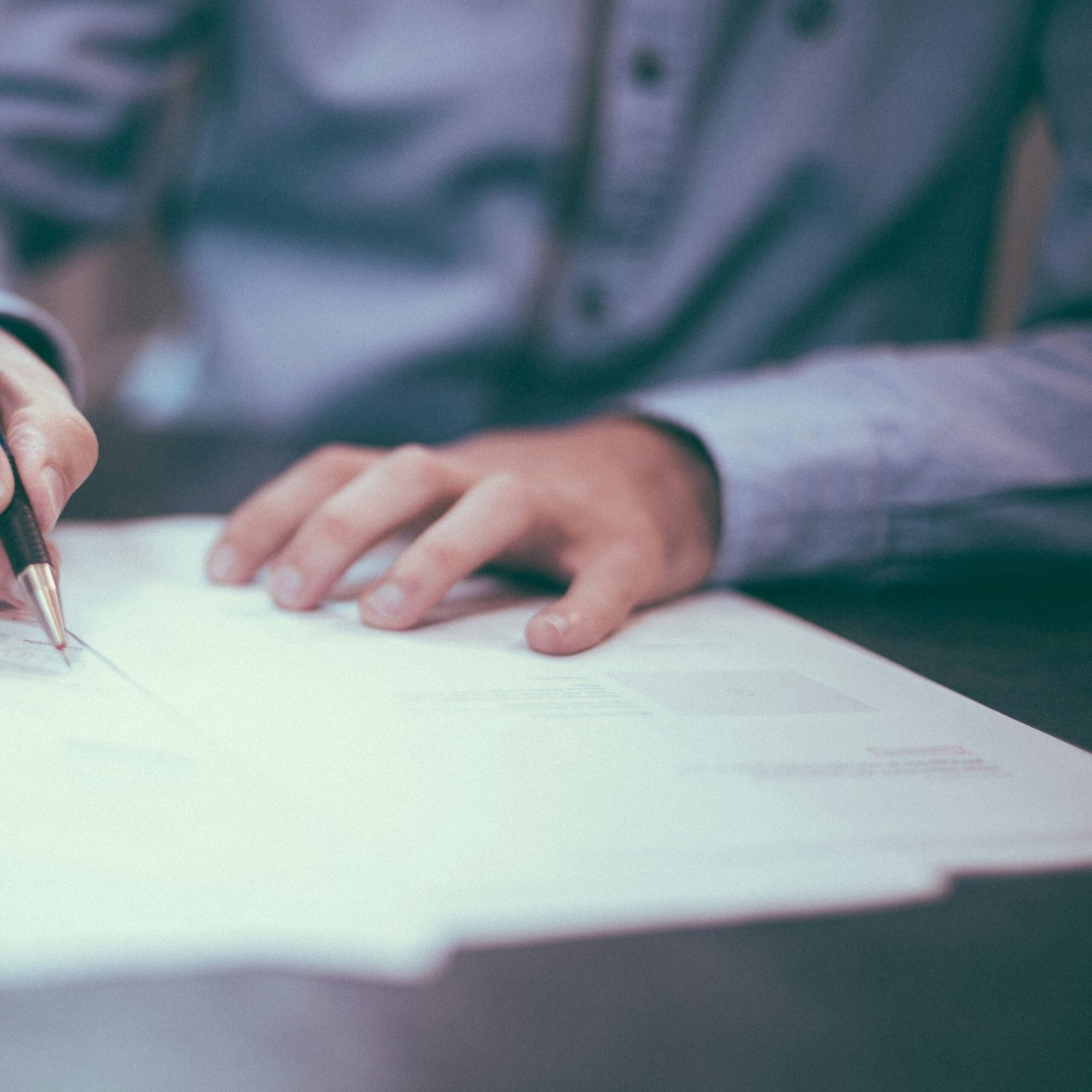 man writing on paper